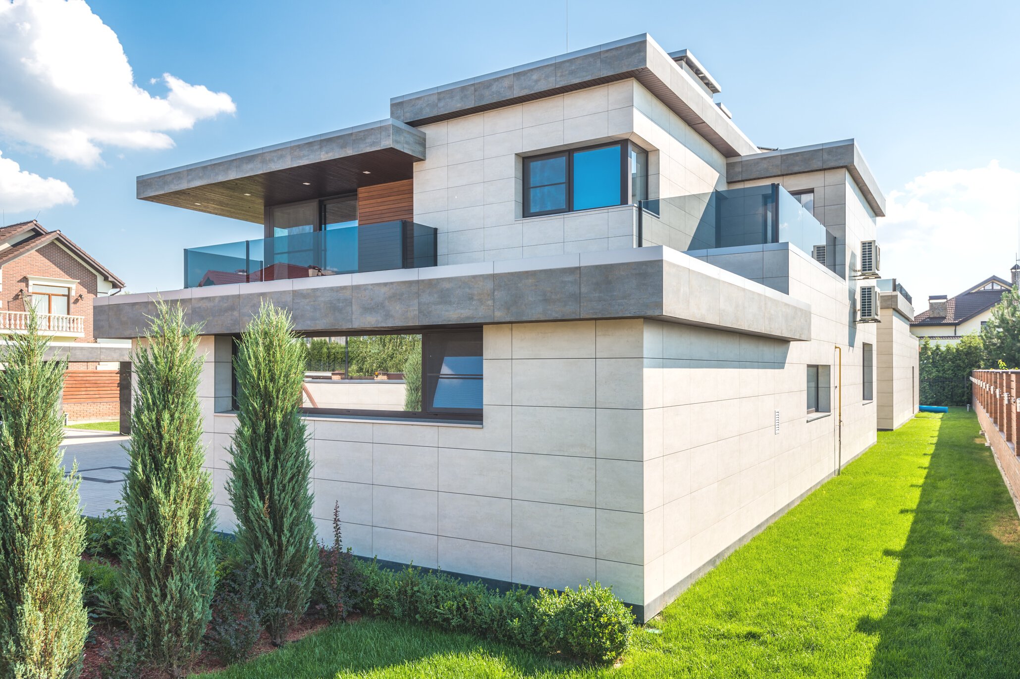 A Modern House Near the Green Grass with Green Plants Under the Blue Sky